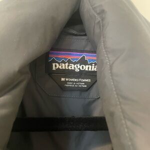 Patagonia wrap over front style down jacket. Navy, size medium.